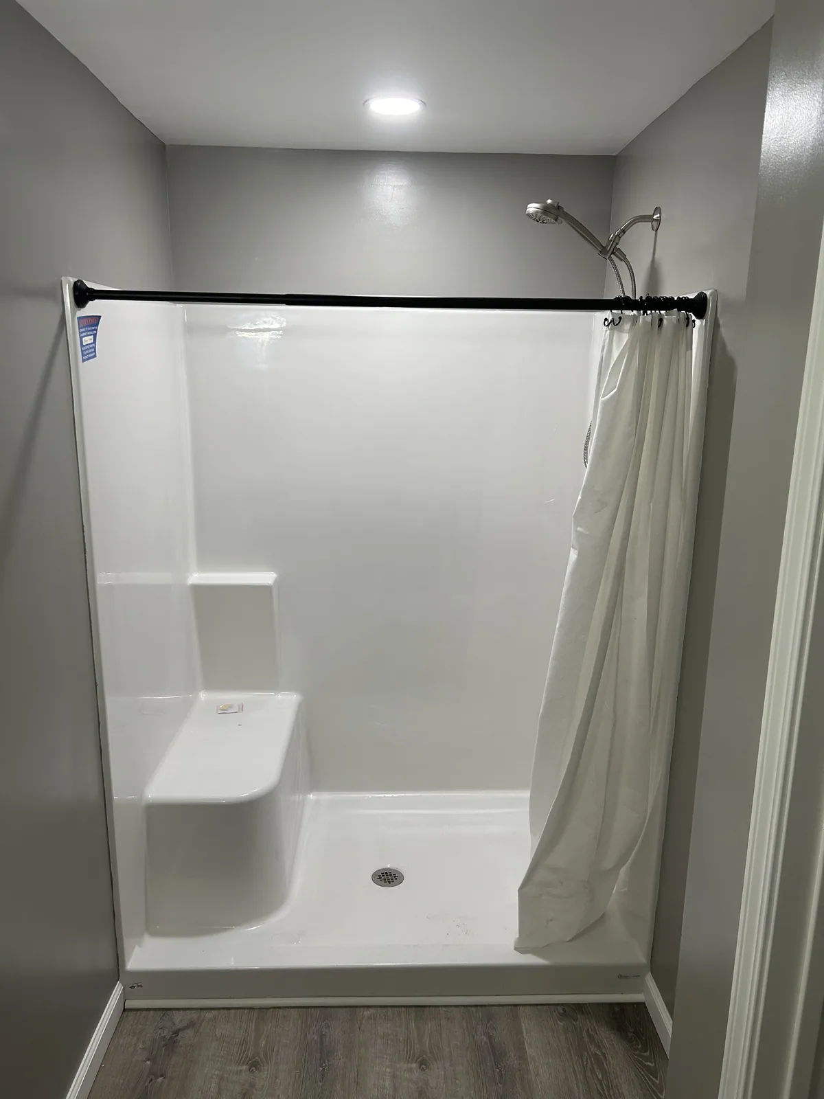 New low-step shower stall installed in a bathroom remodel
