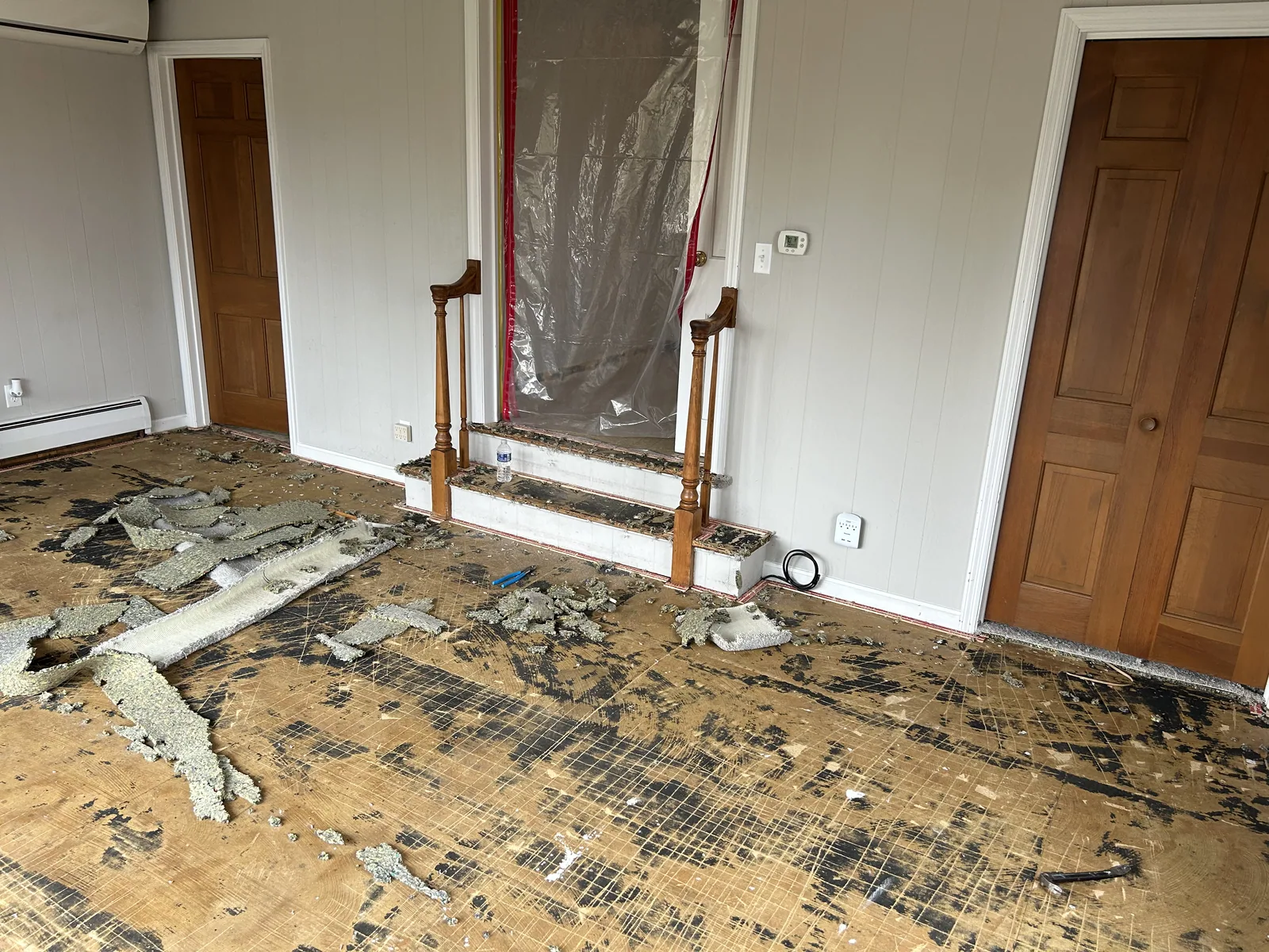 Bathroom stripped to the subfloor with rough plumbing before the remodel