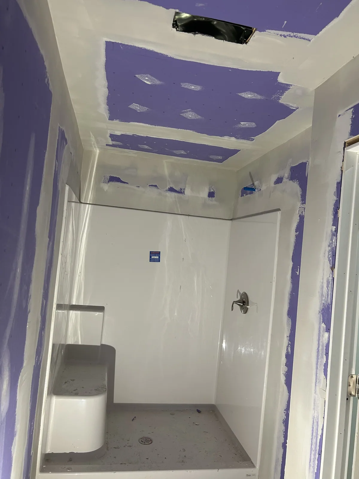 Walk-in shower being waterproofed during a bathroom remodel