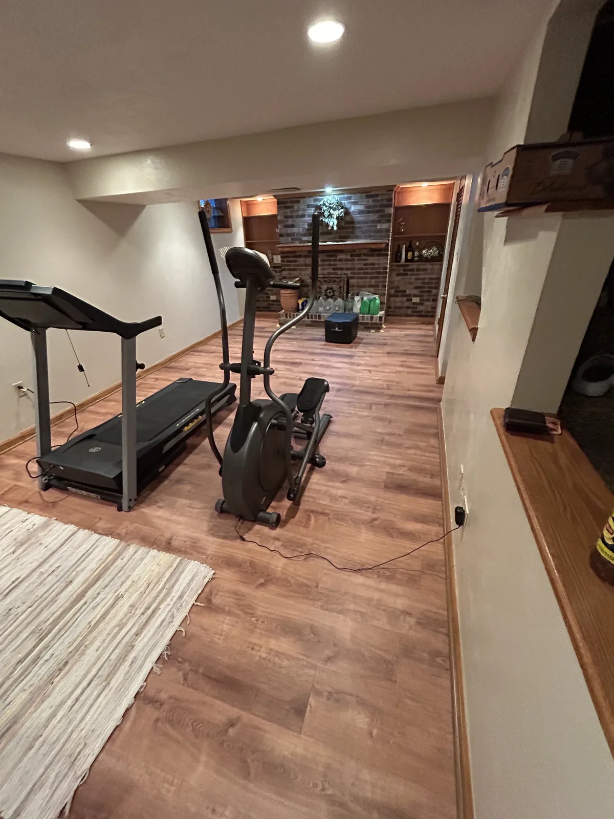 Remodeled living room with recessed lighting and hardwood floors