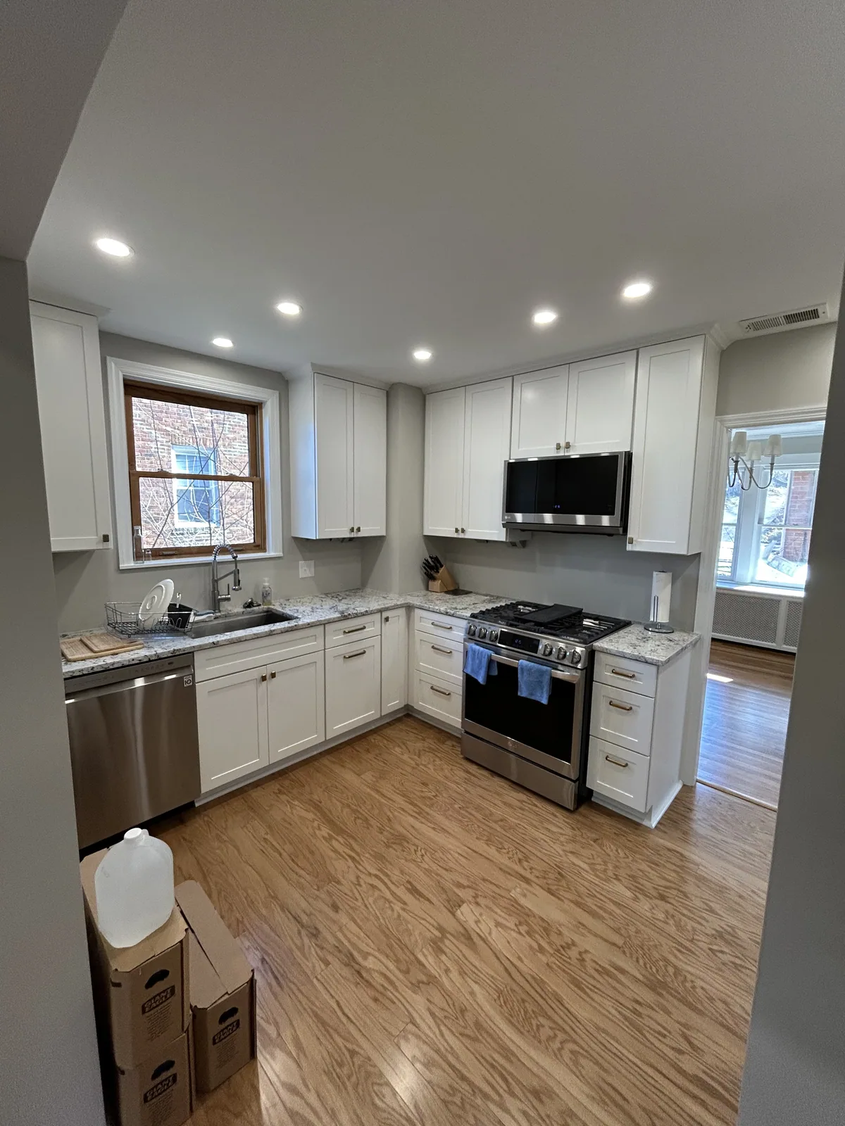 Bright kitchen remodel with white cabinets and stainless appliances