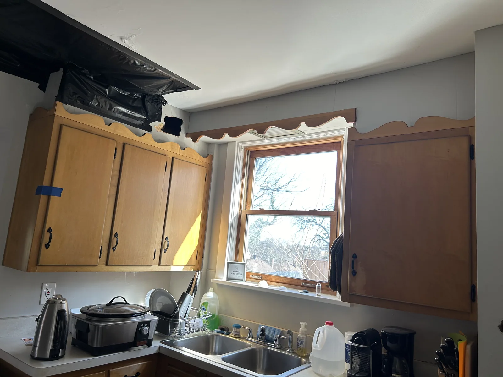 Worn kitchen cabinets and counters before renovation