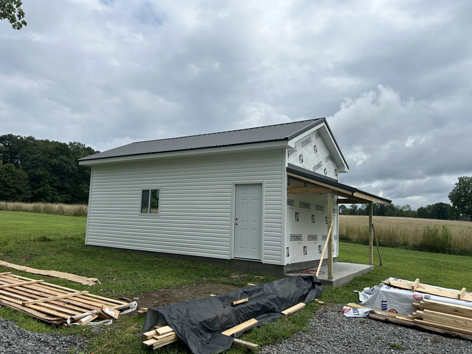 Finished storage shed with siding and a metal roof